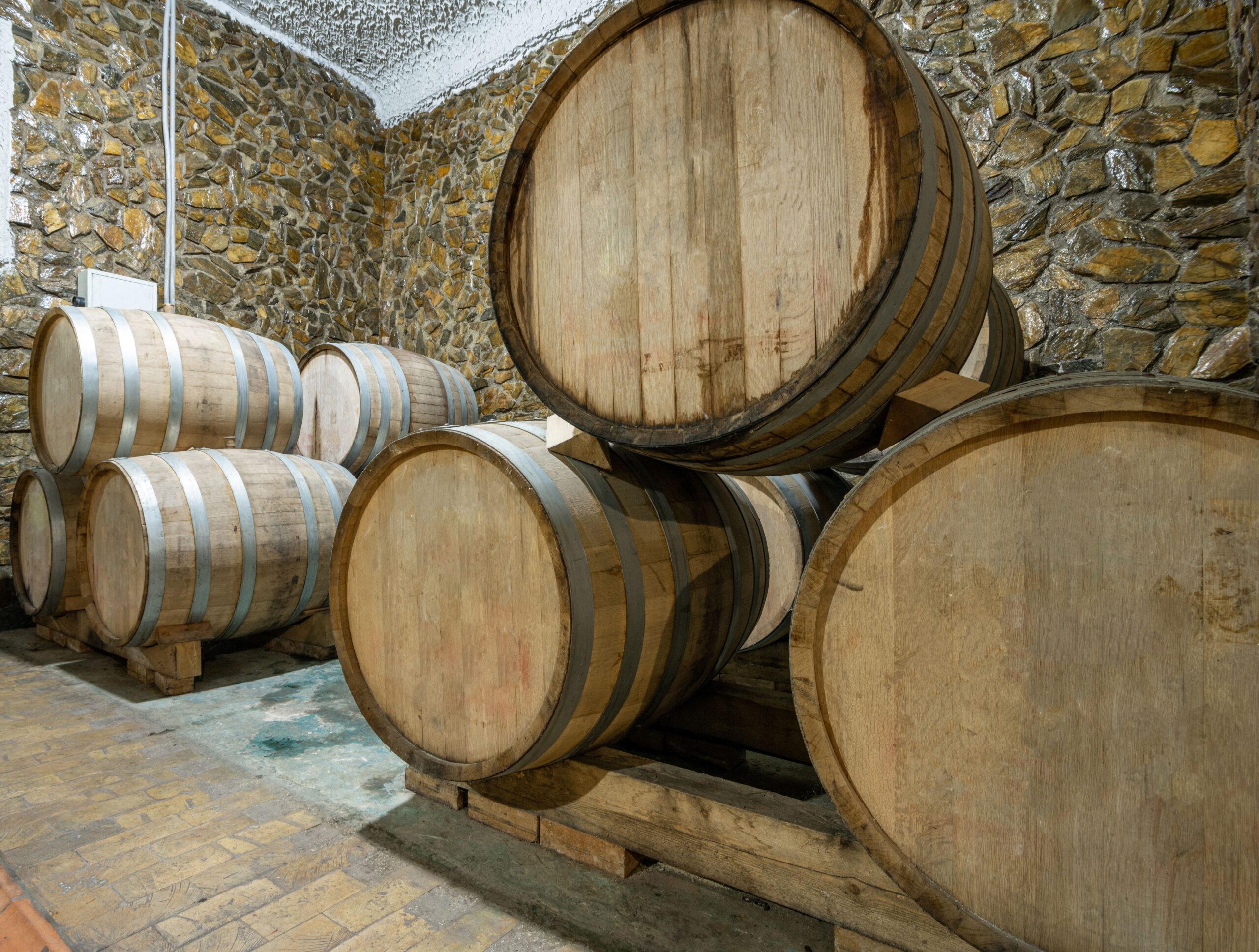 The wooden wine barrels in a wine factory